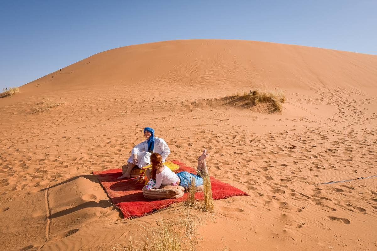 A serene moment in the vastness of the desert on the outskirts of Marrakech, a stark contrast to the city's lively souks.
