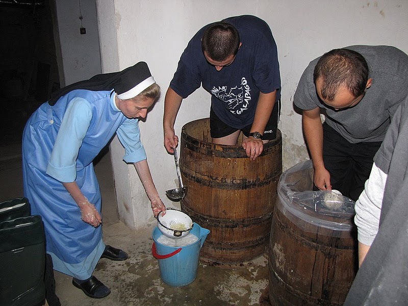 Authentic Polish kapusta kiszona preparation in wooden barrel, highlighting traditional food preservation methods in Poland's culinary practices.