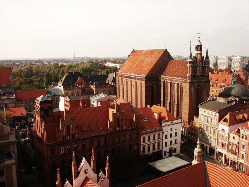 The striking red brick Gothic architecture of St. Catherine's Church in Gdańsk, a testament to Poland's historical cities.
