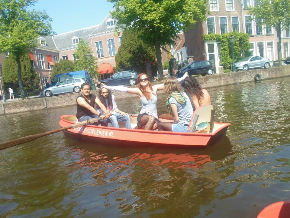 Friends enjoying a boat ride along the Amsterdam canals, a fun activity for an Amsterdam itinerary