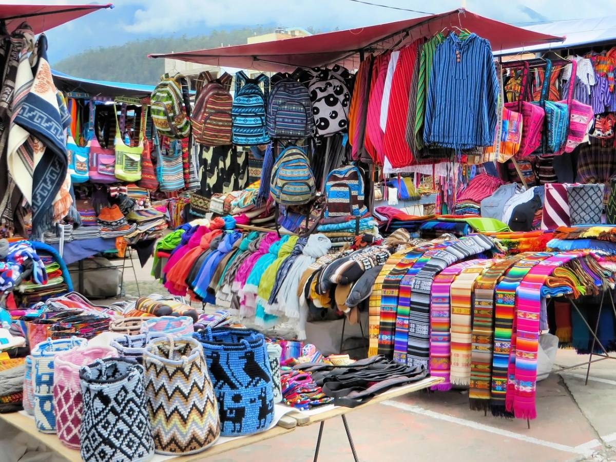 A colorful stall with bright clothing at the Otavalo market, one of the most popular things to do in Ecuador near Quito