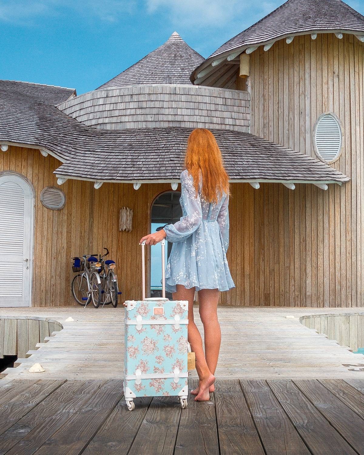 Short blue lace HelloMolly Dress for travel with a matching blue suitcase.