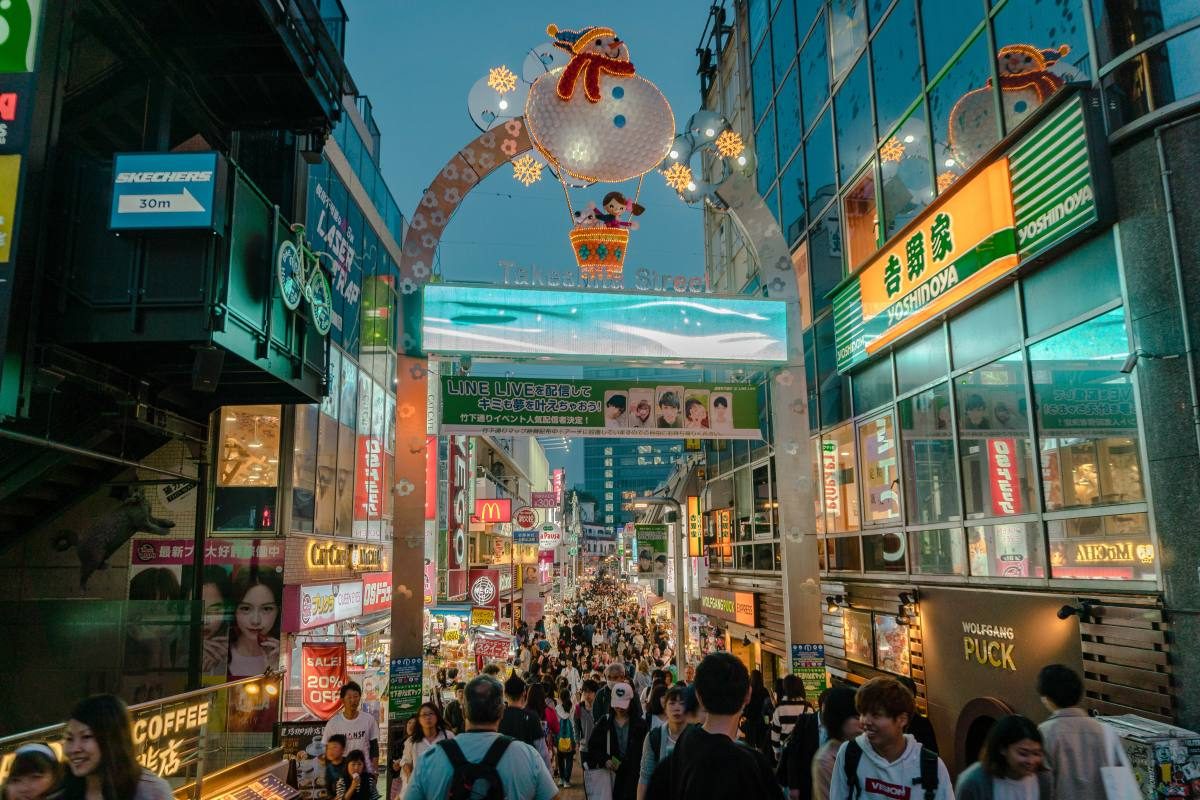 Bustling Takeshita Street in Harajuku, lined with colorful shops, a popular Tokyo attraction.
