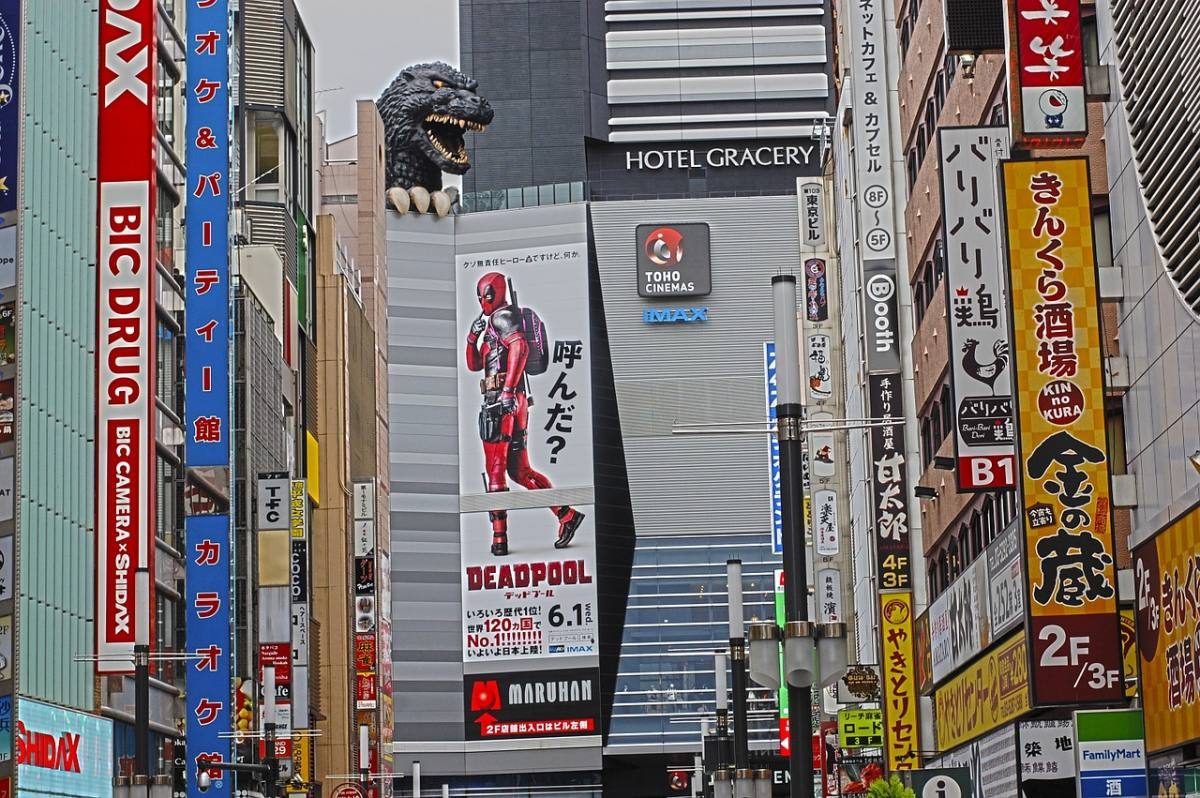 Godzilla looming over Shinjuku's busy streets, adding to Tokyo's dynamic skyline, one of the best things to do in Tokyo