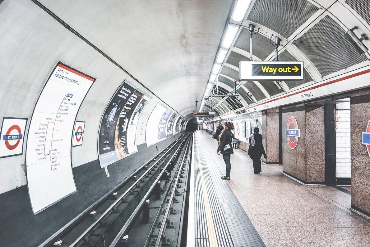 Empty platform of St. Paul's London Underground station, with distinctive roundel logo, offering insights into the convenient and historic transport system in London, vital for tourists to travel like locals.