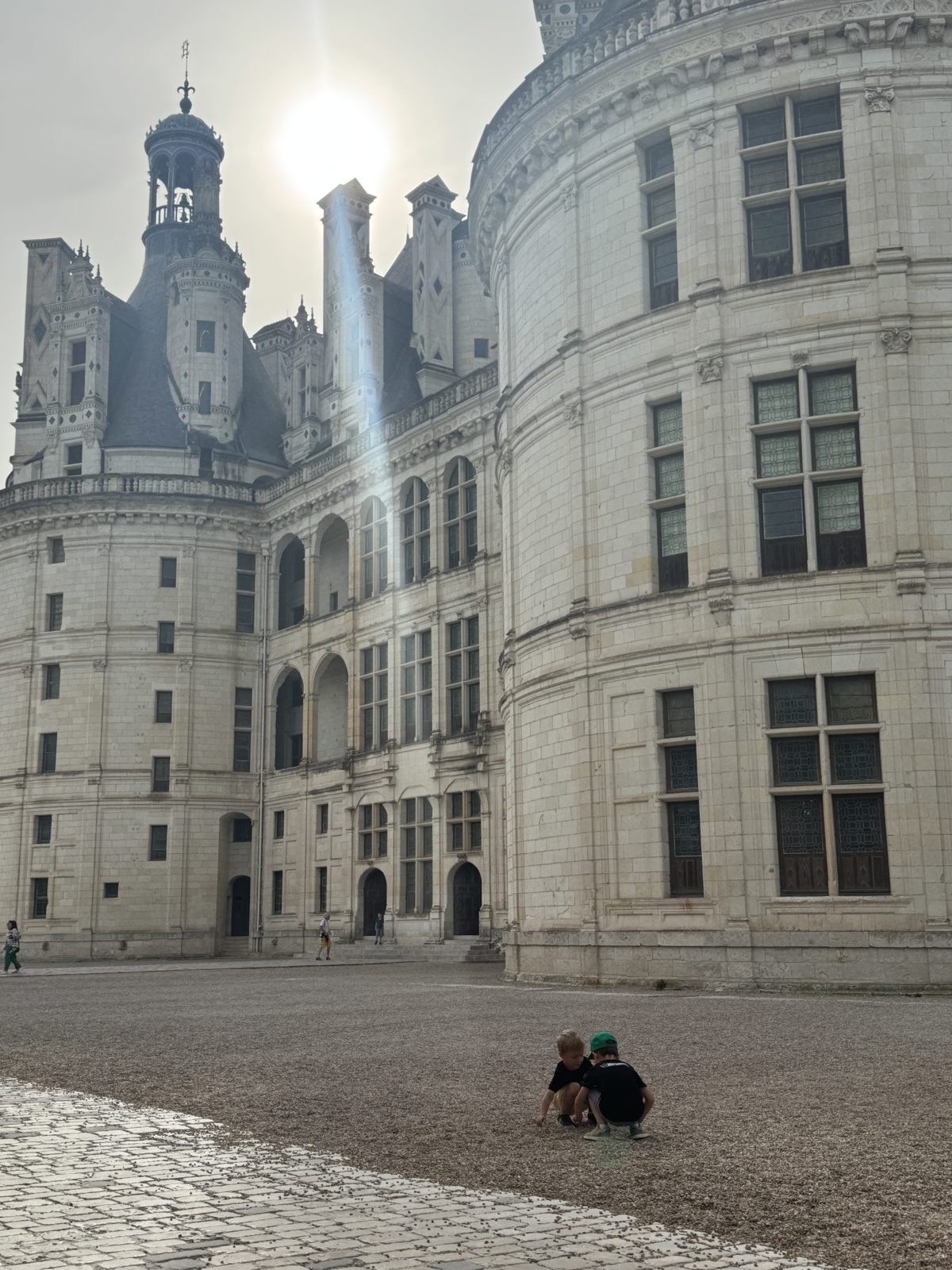 Kids picking up rocks at Chambord castle