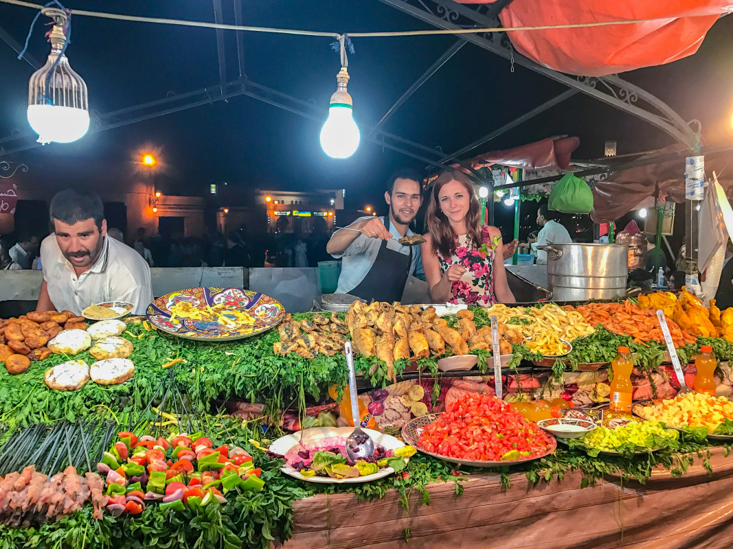 
A vibrant food stall in Jamaa el Fna Square square, a Marrakech night market, where trying local cuisines is a top travel tip for visitors.
