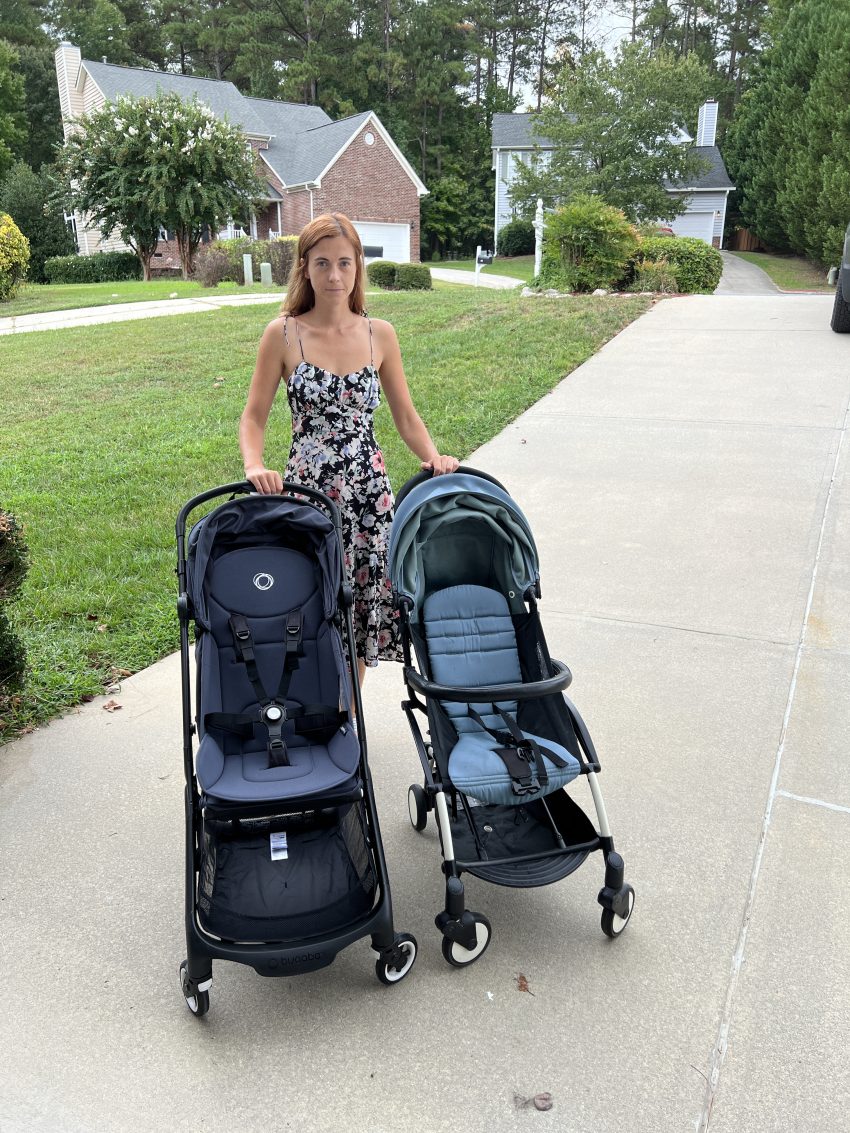 Woman comparing two travel strollers side by side, showcasing their different features and designs.
