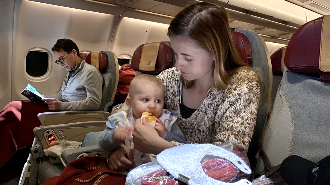 Mother with baby eating on a plane