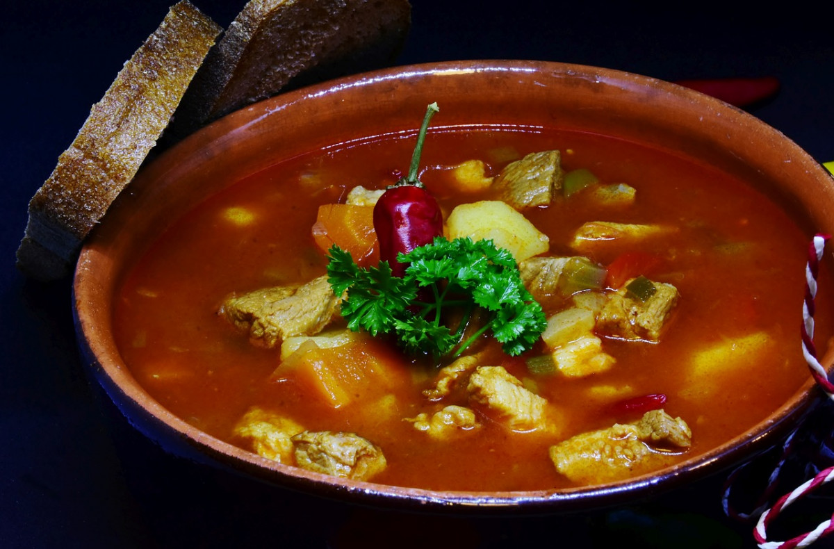 Bowl of spicy Polish pork gulasz, a warming and aromatic dish reflecting the robust flavors found in traditional Polish cooking.