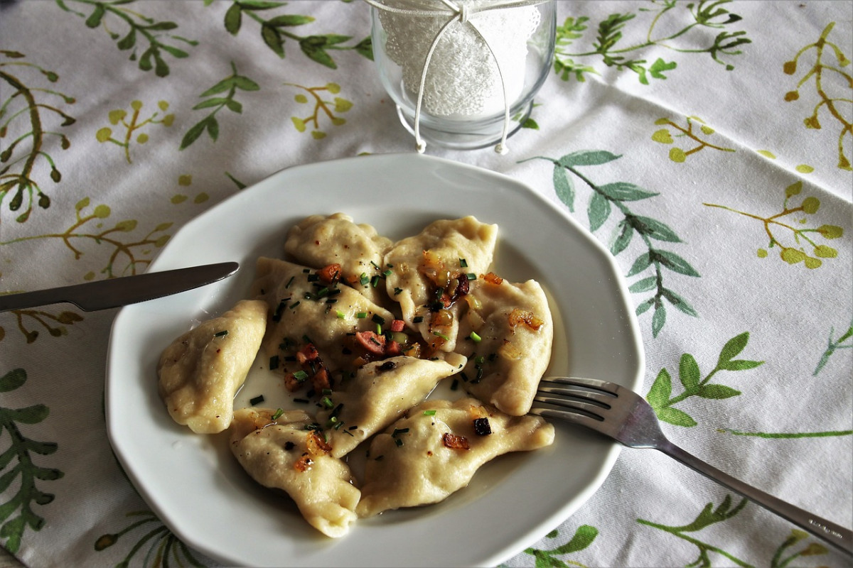 Plate of Pierogi with garnish, a classic Polish dumpling dish, served in a traditional setting, perfect representation of Poland's culinary heritage.