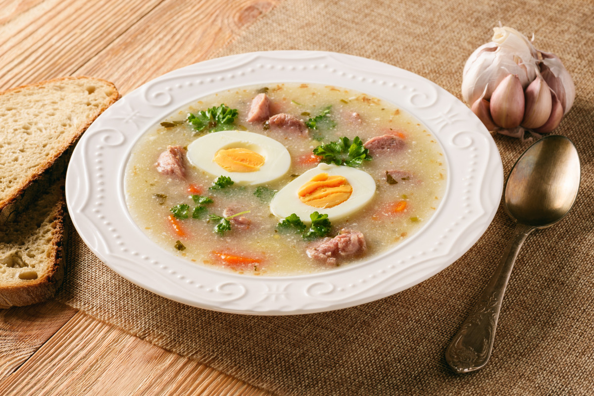 Traditional Polish Żurek soup with sausage and boiled eggs, a flavorful and comforting rye soup showcasing Poland's culinary heritage in soups.