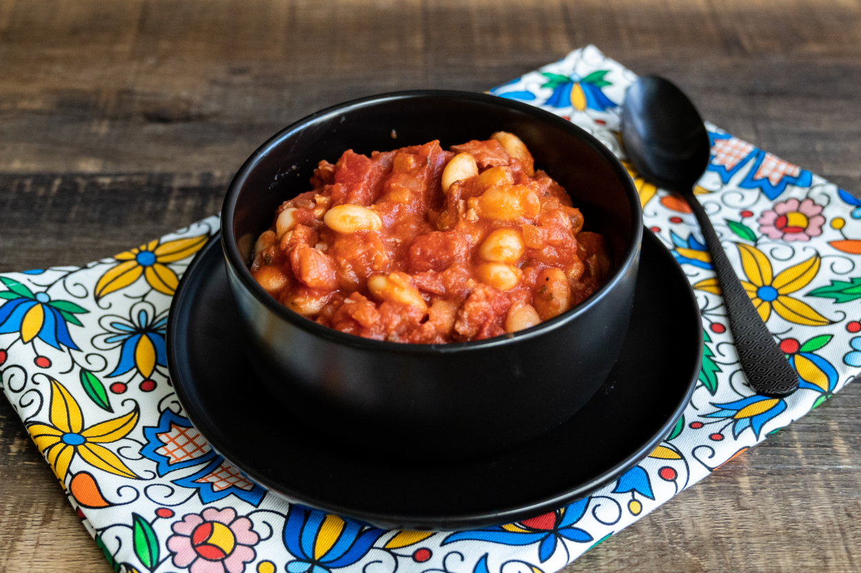 Hearty bowl of Polish bean stew, known as Fasolka po Bretońsku, served in a rustic bowl, a classic example of Poland's robust, bean-based dishes