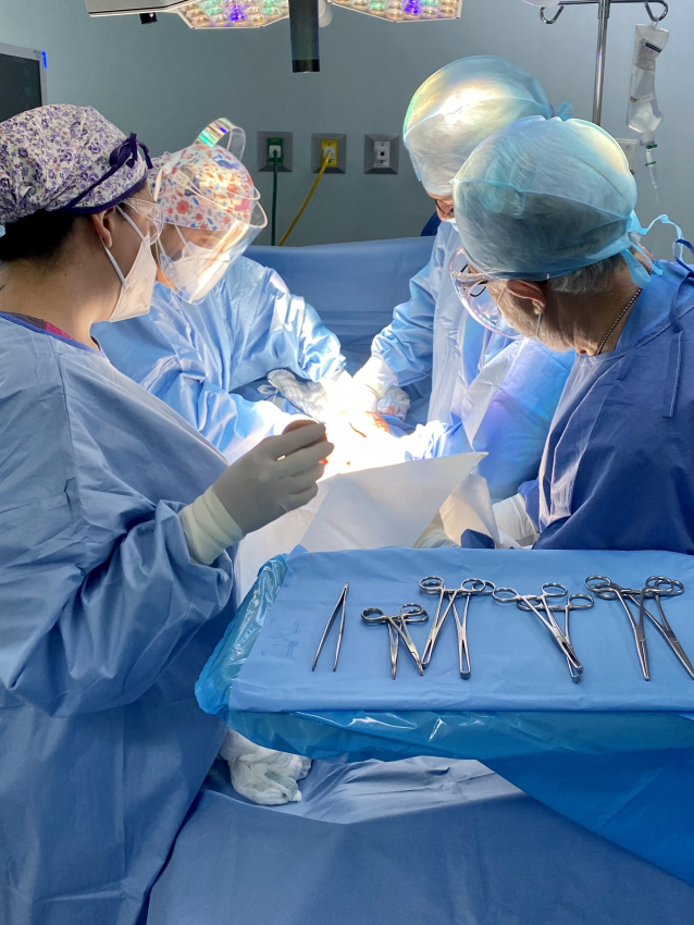 Medical team in scrubs performing a C section birth in a Mexican hospital
