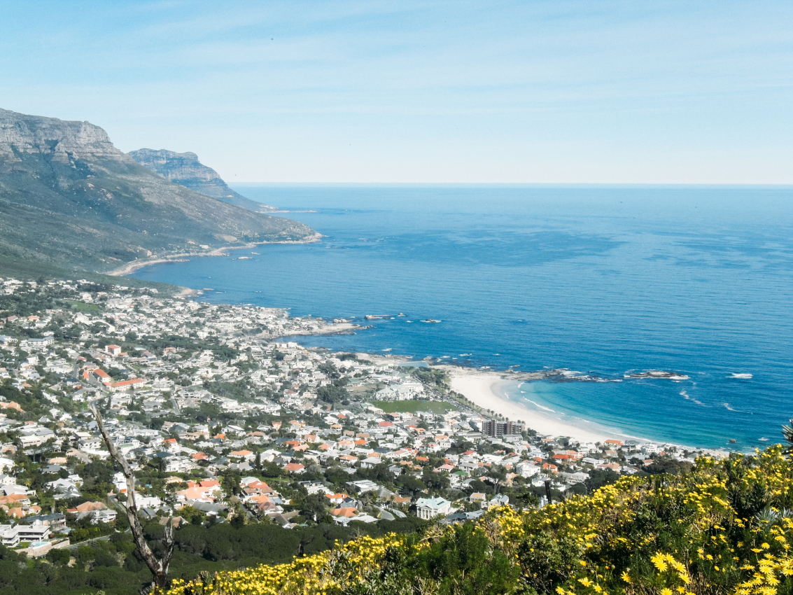 Breathtaking view of the coastal suburb of Camps Bay in Cape Town, with its pristine beaches and crystal-clear waters, a popular destination for beachgoers and sun worshippers.