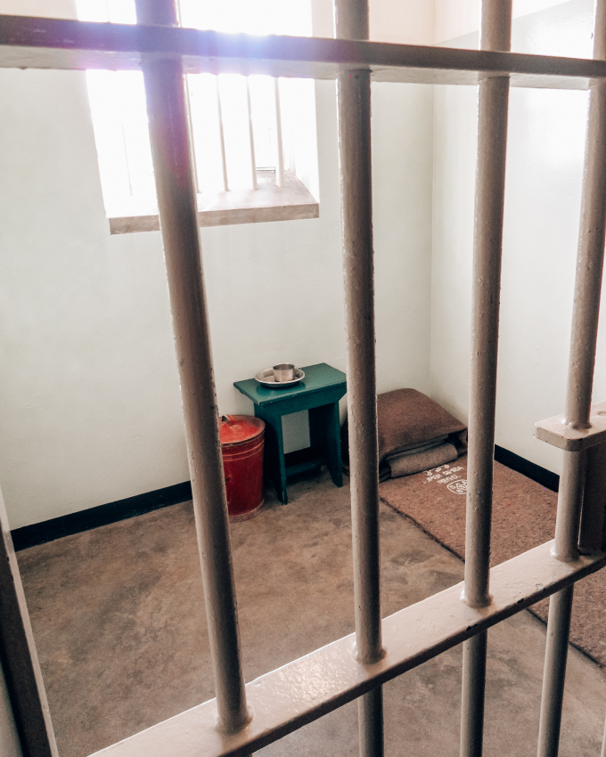 The stark interior of Nelson Mandela's prison cell on Robben Island, near Cape Town, a poignant historical site that's a must-visit for those interested in South Africa’s struggle for freedom.