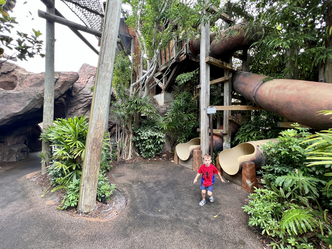 A toddler standing in front of a jungle gym area, enjoying the playful and interactive attractions designed for toddlers at Universal Studios Orlando.
