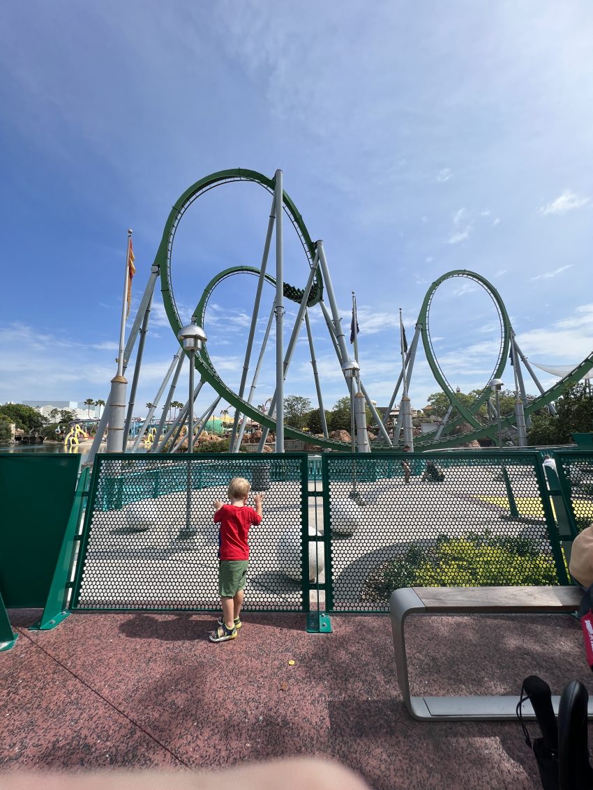 Little toddler marveling at a thrilling roller coaster, a moment of wonder at Universal Studios Orlando with toddlers.
