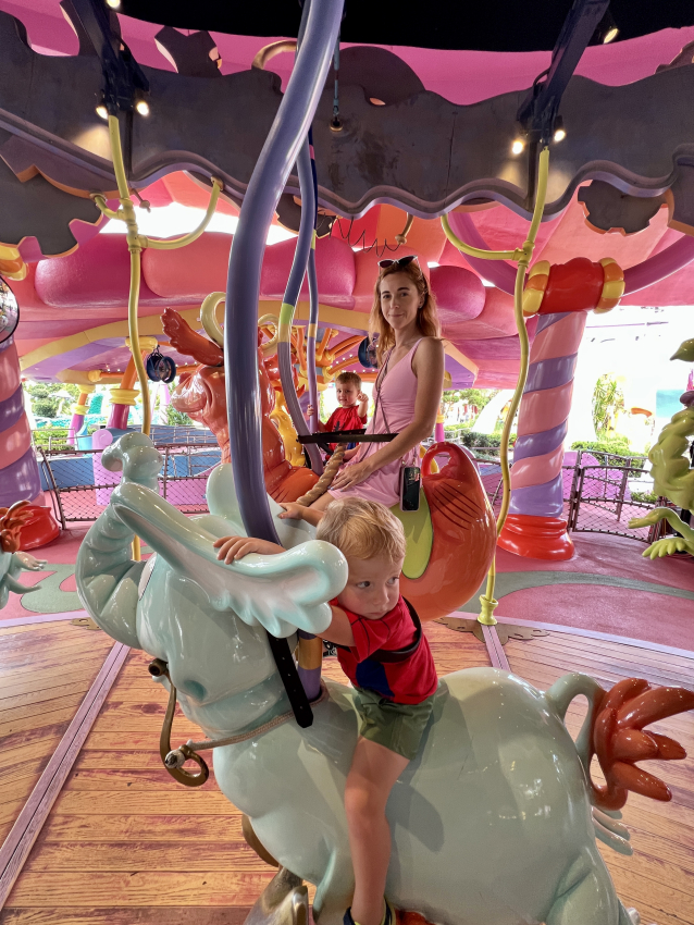 Toddler riding a colorful carousel creature with family at Universal Studios Orlando, tailored for visitors with toddlers.
