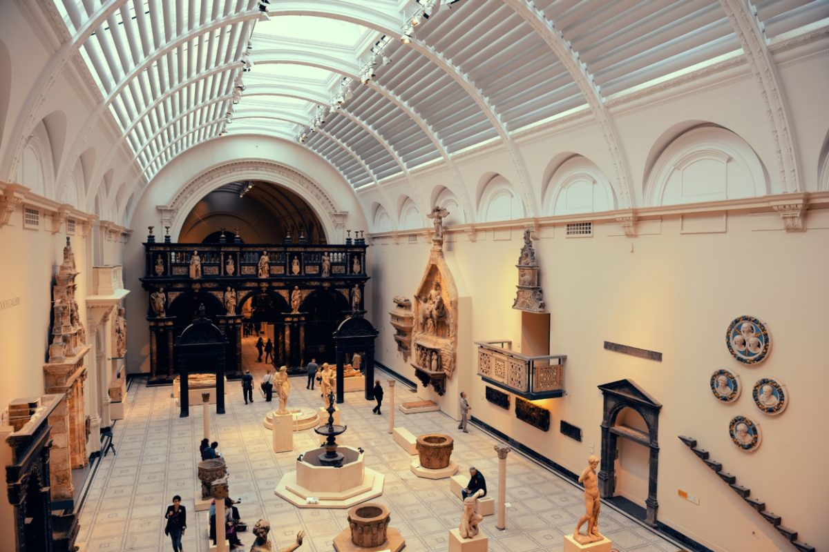 Interior of Victoria & Albert Museum in London showcasing a variety of sculptures and decorative arts beneath an elegant arched glass ceiling, illustrating the museum's reputation as one of the best museums for decorative arts and design in London.
