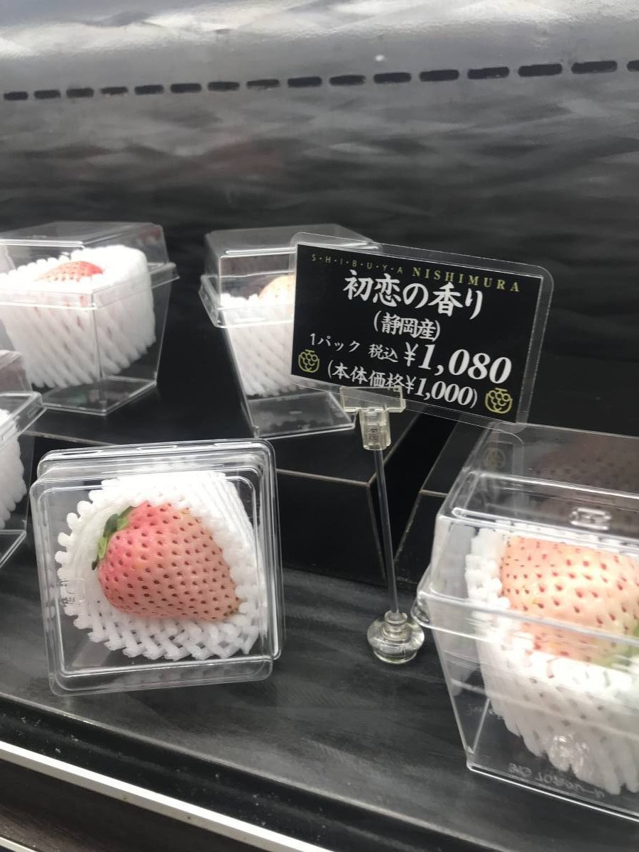 Exquisite white strawberry on display, a luxurious treat found in Tokyo's high-end fruit parlors.